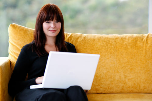 Girl with Laptop on Couch