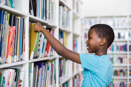 boy picking out book